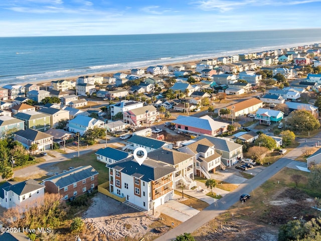 birds eye view of property with a beach view and a water view