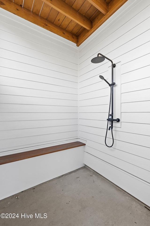 interior space featuring concrete flooring and wooden walls