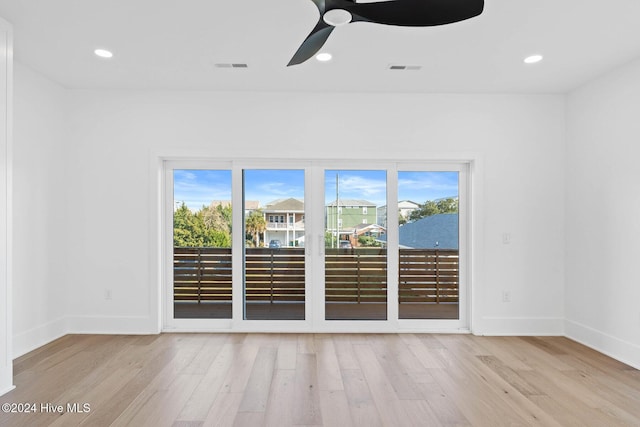 empty room with ceiling fan and light wood-type flooring