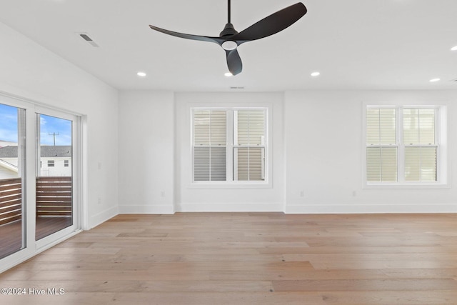 empty room with ceiling fan and light hardwood / wood-style floors