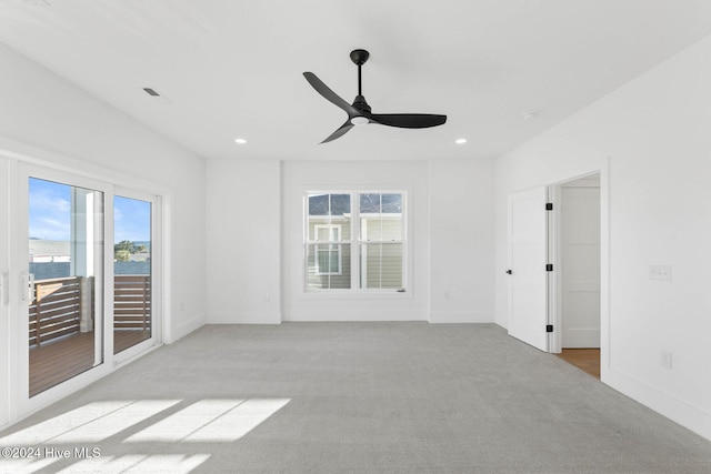 unfurnished room featuring ceiling fan and light carpet