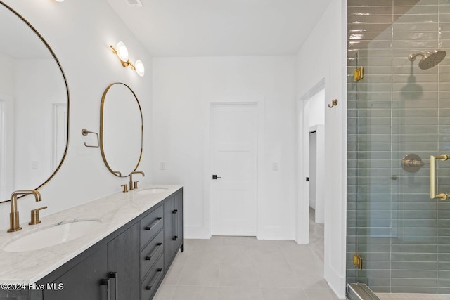 bathroom featuring tile patterned flooring, vanity, and walk in shower