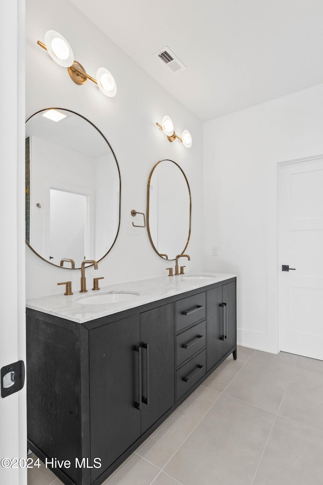 bathroom featuring tile patterned flooring and vanity