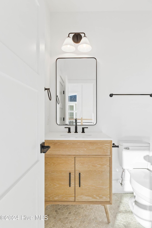 bathroom featuring tile patterned floors, vanity, and toilet