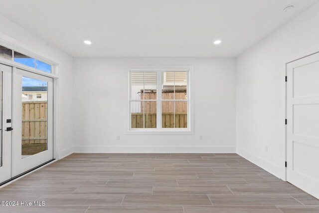 spare room with french doors and a wealth of natural light