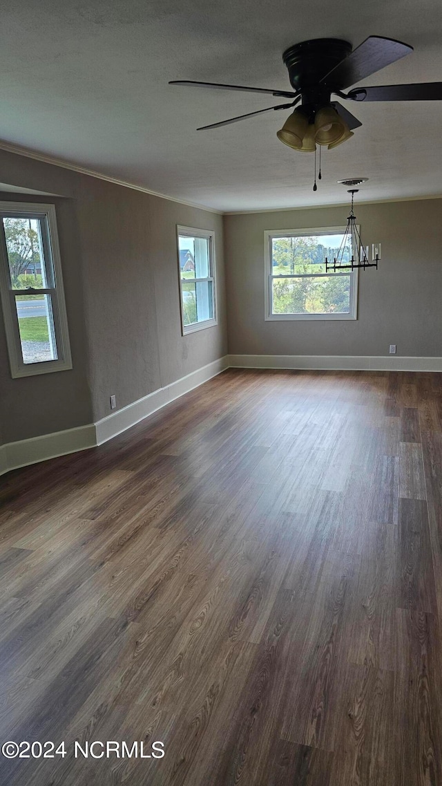 unfurnished room featuring ceiling fan with notable chandelier and dark hardwood / wood-style flooring