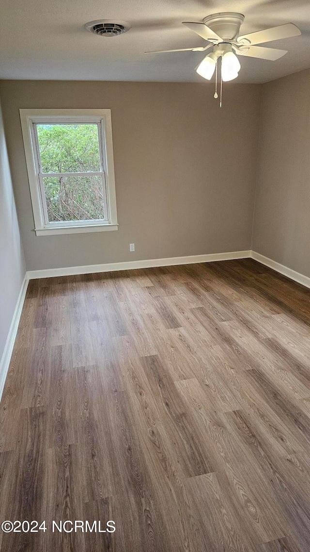 unfurnished room with ceiling fan and wood-type flooring