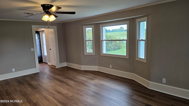 empty room with ornamental molding, dark wood-type flooring, and ceiling fan