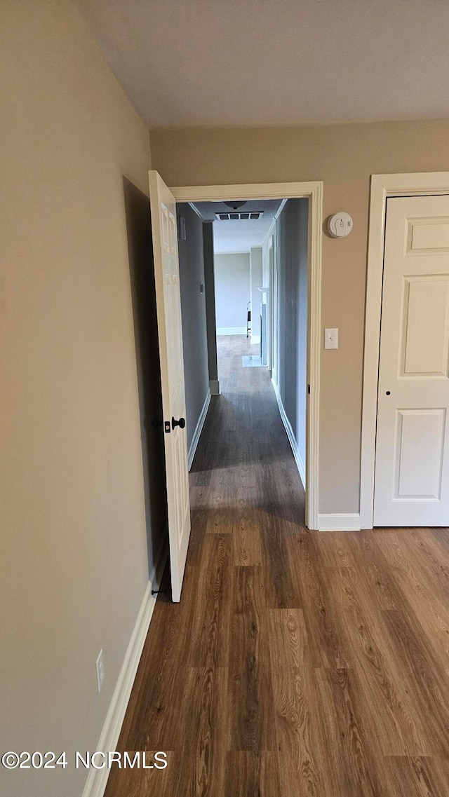 corridor featuring dark hardwood / wood-style floors