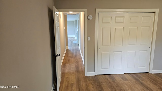 corridor with hardwood / wood-style floors