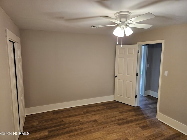 unfurnished room with dark hardwood / wood-style floors and ceiling fan