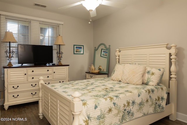 bedroom with ceiling fan and dark hardwood / wood-style floors