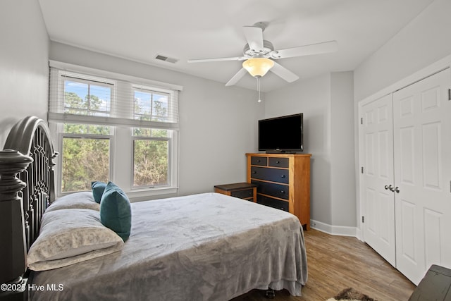 648 Village Park Dr Unit 203, Wilmington, NC 28405 - bedroom with wood finished floors, a closet, a ceiling fan, and baseboards