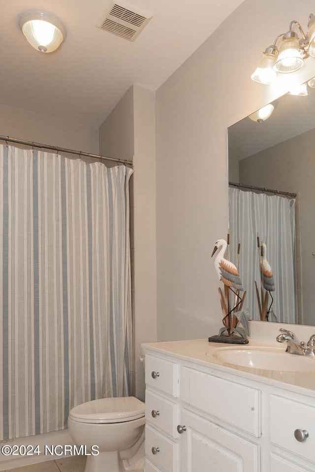 bathroom featuring vanity, toilet, and a shower with curtain