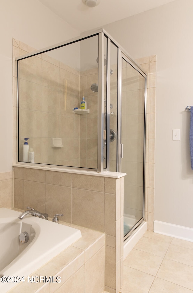 bathroom with shower with separate bathtub, sink, and tile patterned flooring