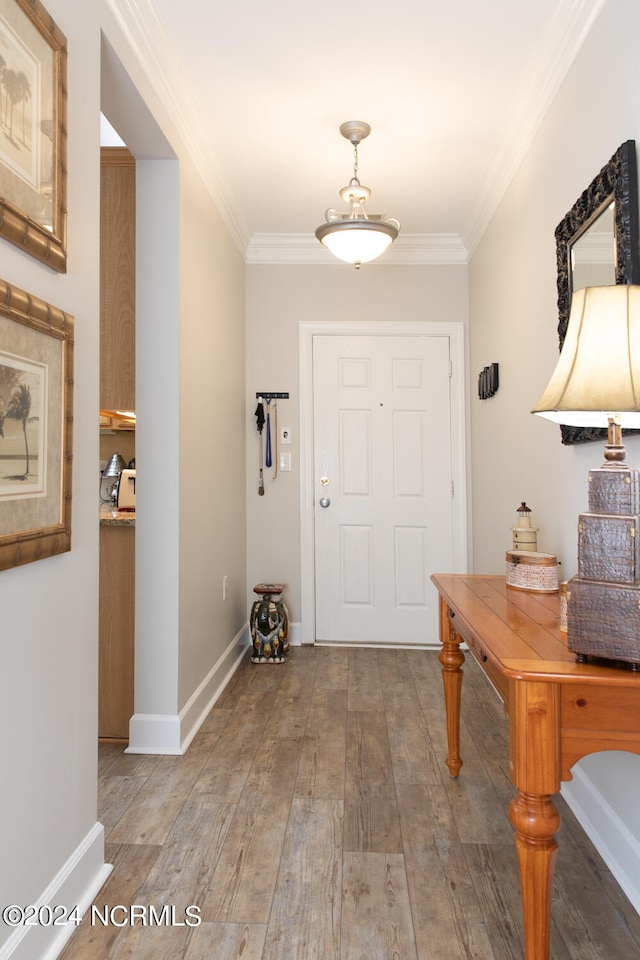 entryway featuring crown molding and hardwood / wood-style floors