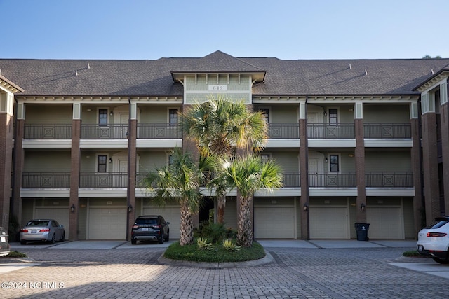648 Village Park Dr Unit 203, Wilmington, NC 28405 - view of building exterior featuring an attached garage and driveway