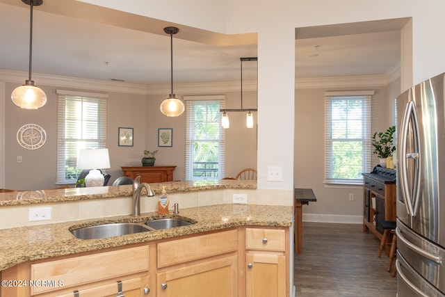 kitchen featuring pendant lighting, stainless steel fridge, sink, dark hardwood / wood-style floors, and light brown cabinetry