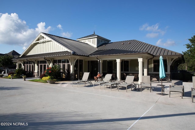 648 Village Park Dr Unit 203, Wilmington, NC 28405 - back of property featuring a standing seam roof, a patio area, metal roof, and board and batten siding