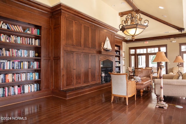 living room featuring beamed ceiling, dark hardwood / wood-style floors, and built in features