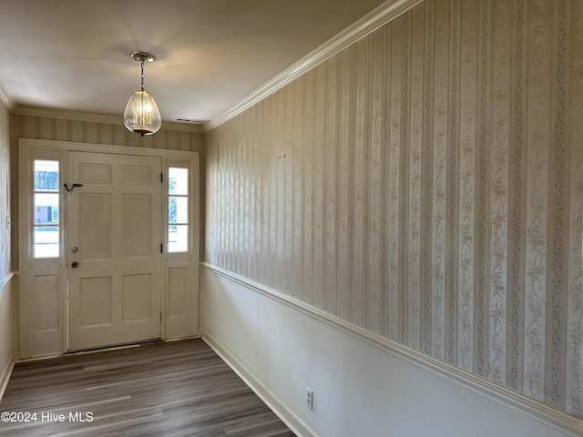 foyer featuring hardwood / wood-style flooring and crown molding