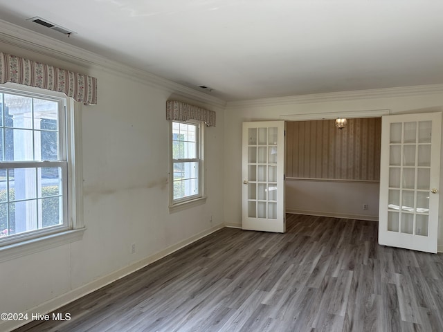 spare room with hardwood / wood-style flooring, crown molding, and french doors