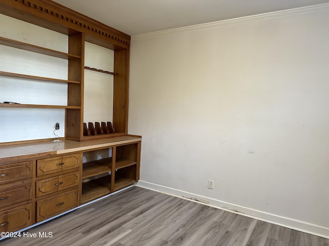 interior space with light wood-type flooring and ornamental molding