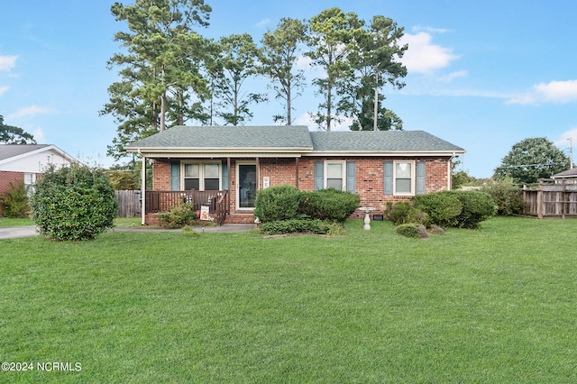 view of front facade featuring covered porch and a front yard