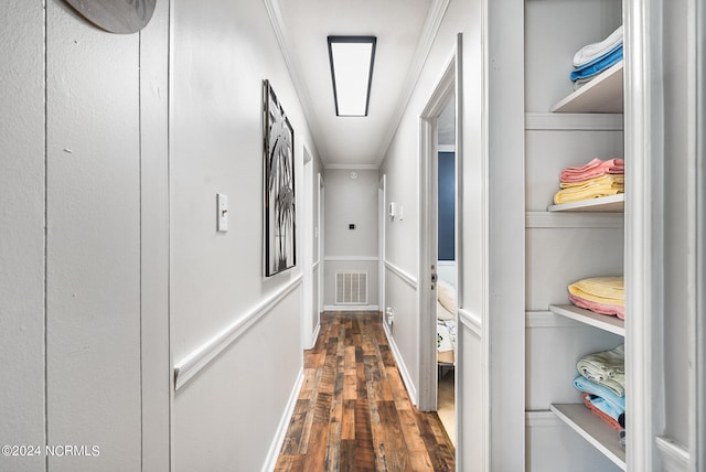 hallway featuring crown molding and dark hardwood / wood-style flooring