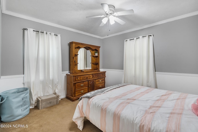 carpeted bedroom with ornamental molding, ceiling fan, and a textured ceiling