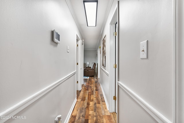 hallway with ornamental molding, dark hardwood / wood-style flooring, and a skylight