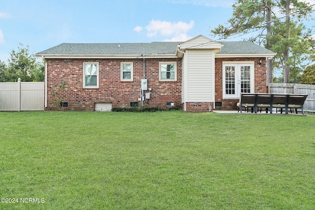 rear view of property with a patio and a lawn