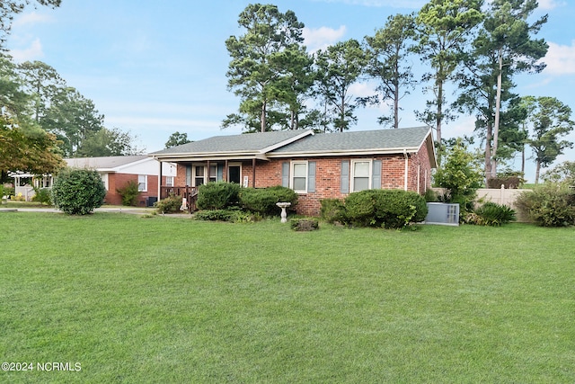 ranch-style house with a front lawn and covered porch