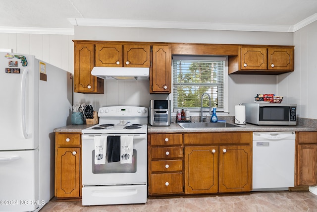 kitchen featuring white appliances, ornamental molding, and sink