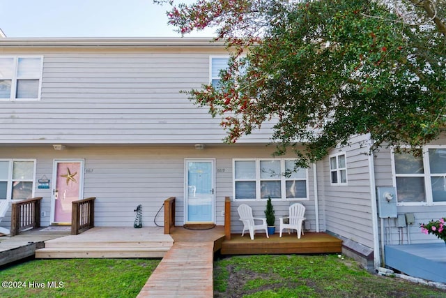 rear view of property with a wooden deck