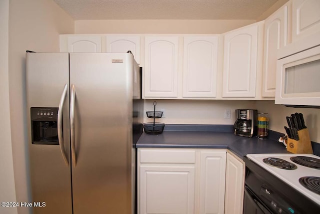 kitchen featuring white cabinetry, white appliances, and a textured ceiling