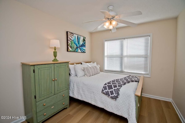 bedroom with hardwood / wood-style floors and ceiling fan