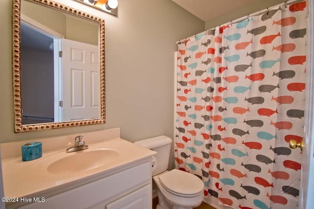 bathroom featuring vanity, a textured ceiling, toilet, and a shower with shower curtain