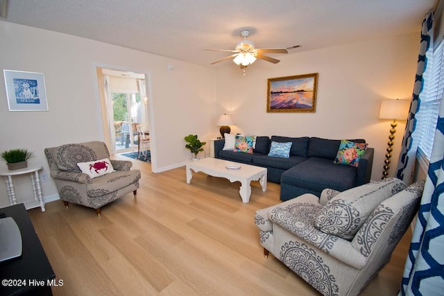 living room with wood-type flooring and ceiling fan