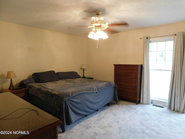 bedroom featuring ceiling fan and light colored carpet