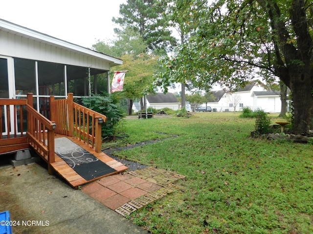 view of yard with a sunroom