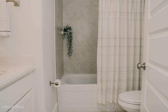 full bathroom featuring vanity, shower / tub combo, and toilet