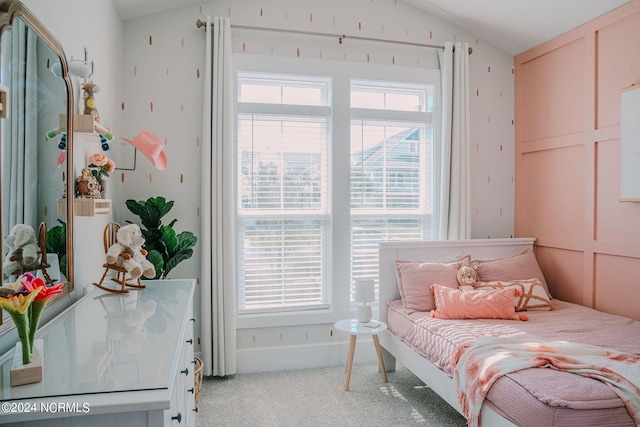 carpeted bedroom with multiple windows and lofted ceiling