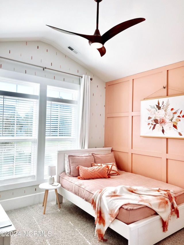 carpeted bedroom with ceiling fan and vaulted ceiling