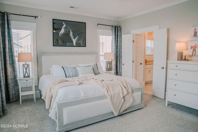 carpeted bedroom with ornamental molding and ensuite bathroom