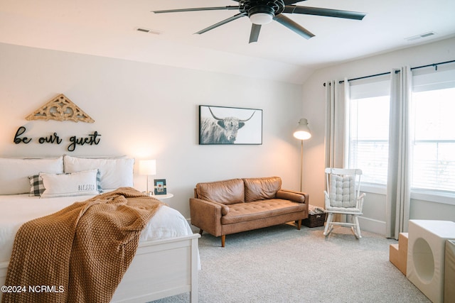 carpeted bedroom featuring lofted ceiling and ceiling fan