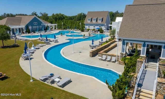 view of pool with a lawn and a patio area