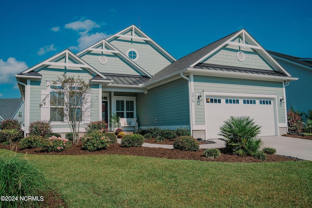 craftsman-style house featuring a garage and a front lawn