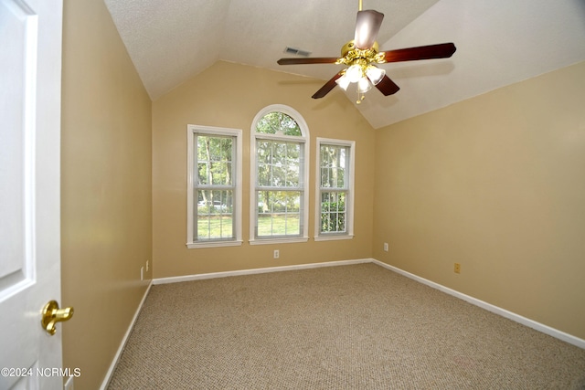 carpeted empty room featuring ceiling fan, a textured ceiling, and lofted ceiling