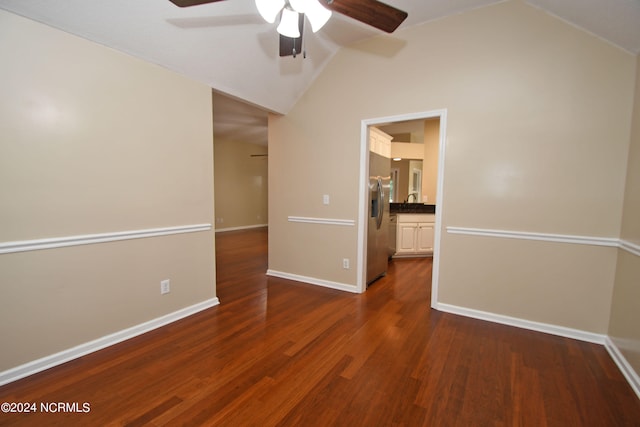 empty room featuring lofted ceiling, dark hardwood / wood-style flooring, and ceiling fan